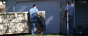 Two Men Opening a Roll Off Dumpster